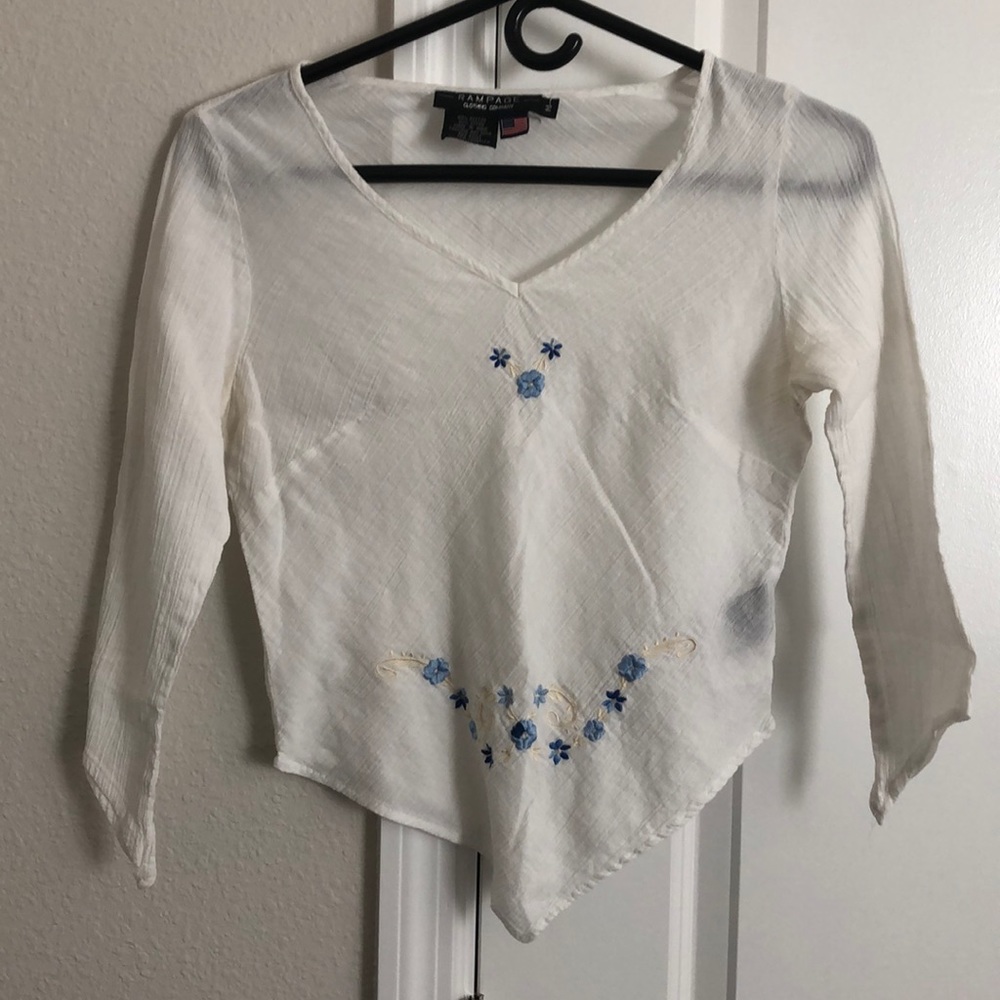 Unique cut top w/blue embroidered flowers.
